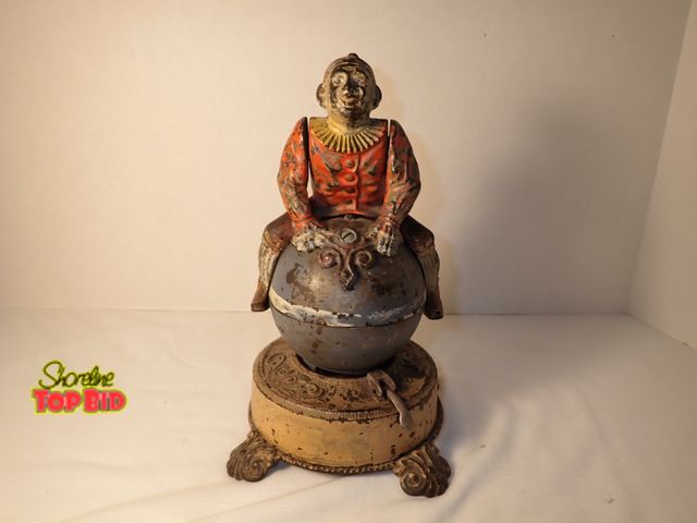 Lot 59-20073 - Antique Original Cast Iron "Clown on Globe" Mechanical Bank by James H. Bowen Manufactured by J &amp...