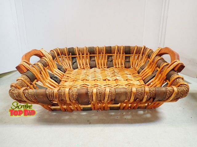 Lot 59-41654 - Large rattan basket edged in twine around top wooden handles measure's 20.5" long 18" wide 5" deep a...