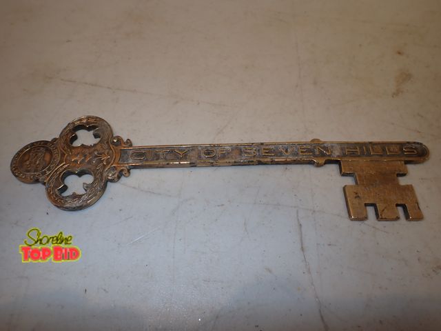 Lot 59-14541 - Ca. 1920 Brass 9" Key to the City of Seven Hills, embossed. Also, on top of key City of Rome, Georgi...