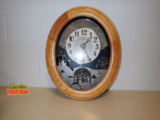 Lot 59-33006 - Rhythm "Small World" Magic Motion Clock known as Joyful Timecracker Oak Model Magic Motion Music Wal...