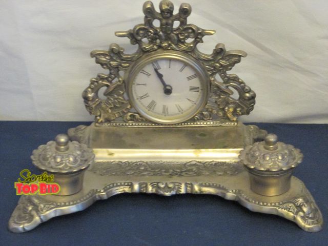 Lot 59-10054 - Vintage pewter Cherub double ink wellclock. solid, inkpots included, clock does not work.