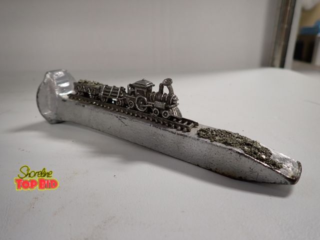 Lot 59-14347 - Vintage Railroad Spike Art with Mini Pewter Train &amp; Pirate Train Art 6 3/4" long