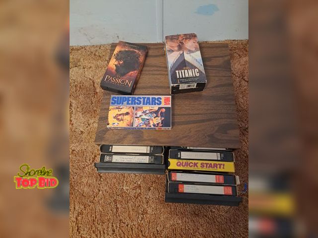 Lot 59-76028 - 28 vhs tapes..mostly old movies and storage case