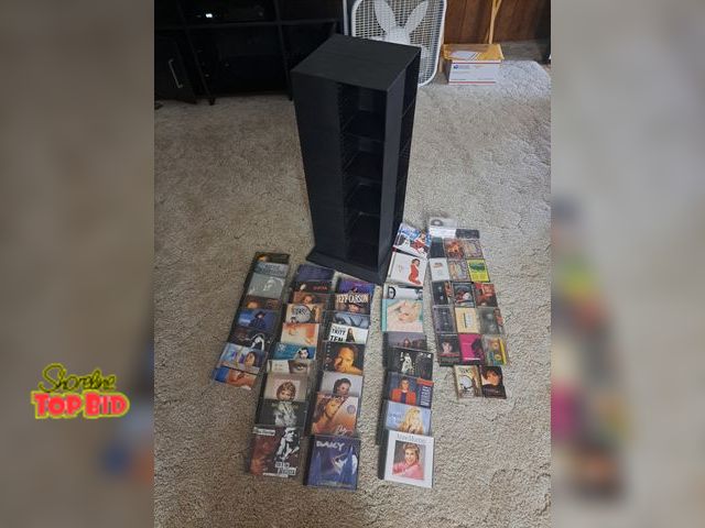 Lot 59-76007 - 34 cd's...20 cassette tapes..3 blank tapes can tower case 28" x 10"