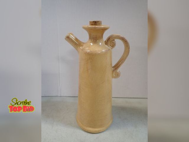 Lot 59-41652 - Pier One yellow pitcher with cork small chip on spout. 10" tall 4" in diameter at base