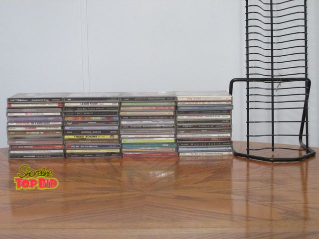 Lot 59-10115 - 52 CDs, rock, country, etc.. in their factory cases, &amp; 30"T CD tower