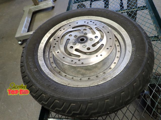 Lot 59-21092 - OEM Harley-Davidson Solid Aluminum Wheel equipped with a brake rotor iconic "dish" style wheel