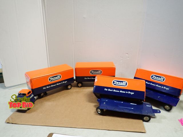 Lot 59-20064 - Rare 1950s Friction Rexall Tin Toy Tractor and 4 Box Trailers, 2 Need Reattached to Bottom