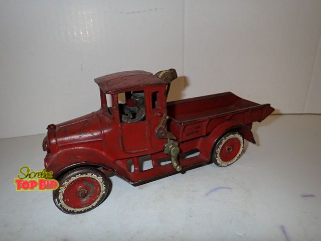 Lot 59-10313 - 1930s Arcade Dump Truck "Red Baby" Cast Iron Toy 4 1/2" x 10 1/2" x 3 1/2" width with Driver. Great ...
