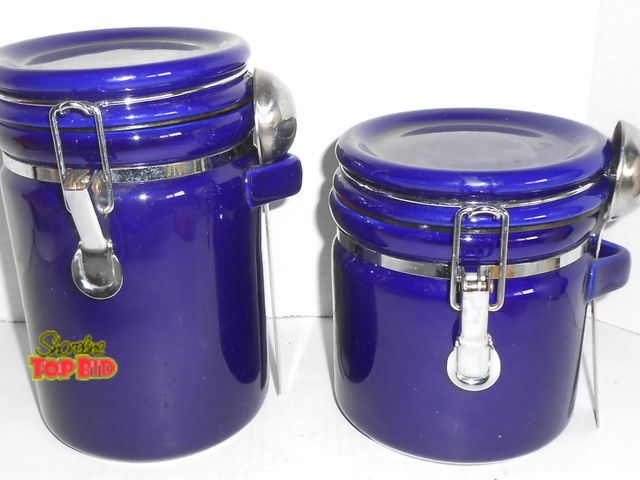 Lot 59-74357 - 2 Beautiful Cobalt Blue Hinged Canisters with Spoons.  1 Measures 8" tall, 1 measures 6".