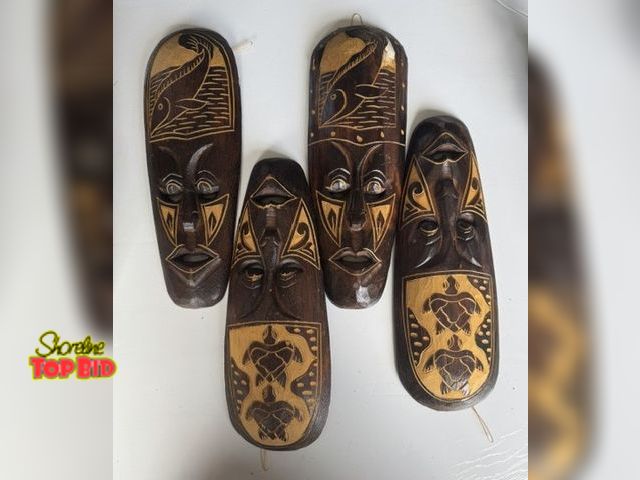 Lot 59-20191 - Four carved wooden 4" x 11" tribal masks ready to hang