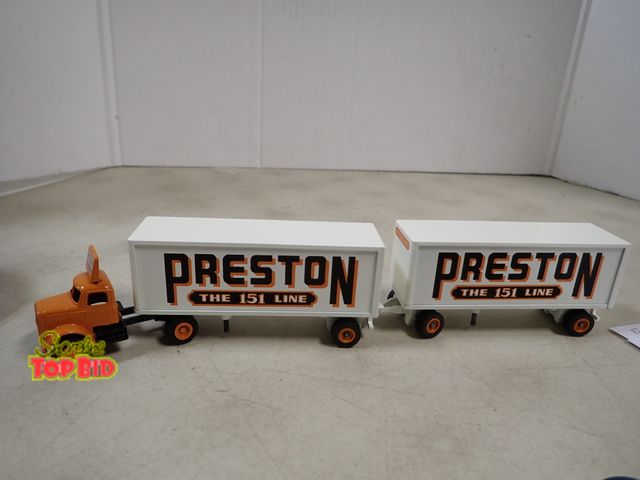 Lot 59-41825 - Winross 1/64 scale die cast day cab with 2ea. 28ft Preston trailer