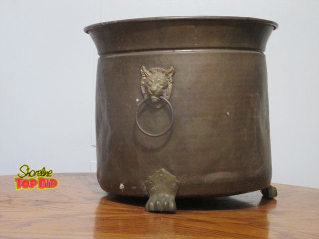 Lot 59-10103 - Big ornate brass outdoor planter, lions heads on sides, clawfoot legs.  15"T, 17"D across top openin...