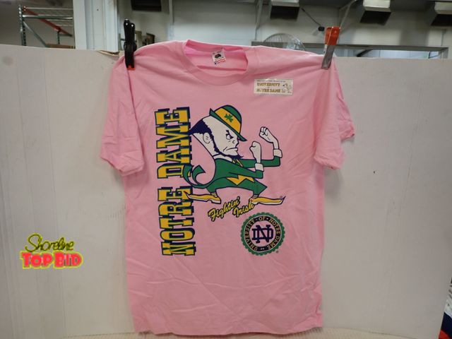 Lot 59-13149 - New Old Stock Vintage 1990s Notre Dame Fighting Irish Graphic T-Shirt Uniquely Styled in Pastel Pink...