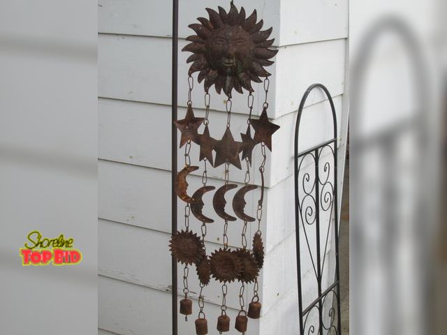 Lot 59-10061 - 36"T ornate brass hanging wind chime.  Solar themed, sun, moon, stars, etc..  Looks good, swings goo...