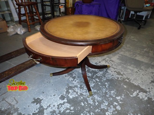 Lot 59-41506 - Mahogany antique leather top center round table brass castors and 1 drawer