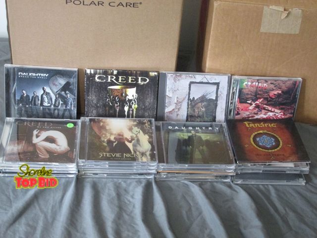 Lot 59-10021 - 23 assorted music CDs from the 80s and 90s.  Most common are Staind, Daughtry, Red Hot Chili Peppers...