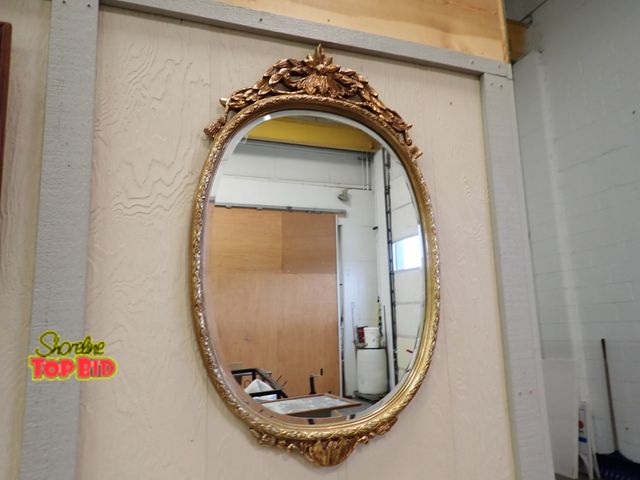 Lot 59-13088 - Ornate Oval Wall Mirror, A Classic Gold Gilt Finish, Prominent Carved Floral Crest at Top 42" x 26"