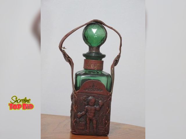 Lot 59-10120 - 12"T Leather quart size liquor bottle holder; contains a dark green bottle with a round stopper in i...