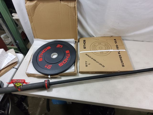 Lot 7-131879 - Ethos 7 ft. Barbell with (2) New Ethos 10 lb. bumper plates. NO clips.