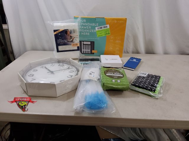 Lot 7-134634 - Lot of miscellaneous household items. Includes Pugg wall clock, journal, moth traps, adhesive wall h...