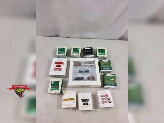 Lot 7-123475 - (12) Boxes of assorted Hallmark miniature train Christmas tree ornaments.