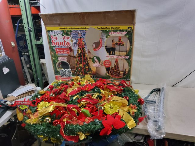 Lot 7-131708 - Works but Missing Santa topper and remote. Approx. 7 ft. Tall pre-lit decorated artificial Christmas...