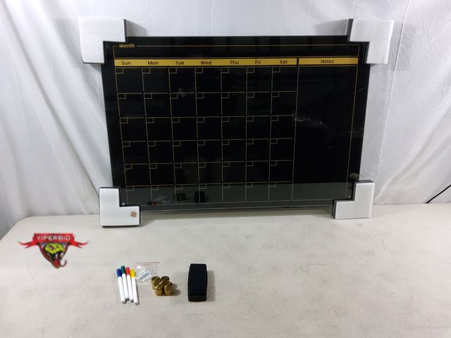 Lot 7-134021 - Frameless monthly calendar. Black tempered glass with gold pirnt. 24" X 26". Includes markers and er...
