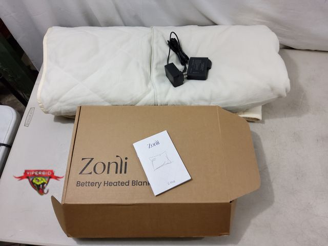 Lot 7-130504 - Zonli 3-in-1 portable battery operated throw. Power bank included. Can be used as throw, cloak or pi...