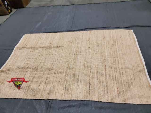 Lot 7-135001 - S &amp; L Homes 6 ft. X 9 ft. Jute handwoven rug. Few pulls.