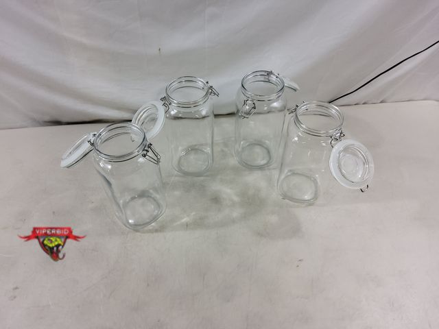 Lot 7-130172 - Lightly used- Needs cleaning! (4) Glass jars with locking lids. 10"H. Bottom dia. 4-1/2". Top diamet...