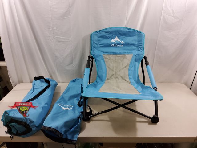 Lot 7-131040 - (2) Oileus low beach chairs with carrying bags.