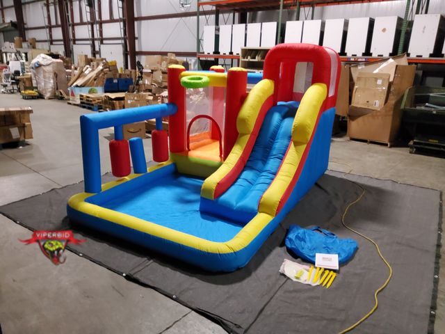 Lot 7-134052 - Inflatable bounce house with slide &amp; blower.  148" X 96" X 84"H.