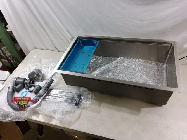 Lot 7-132973 - 33" X 19" Stainless steel kitchen sink with accessories.
