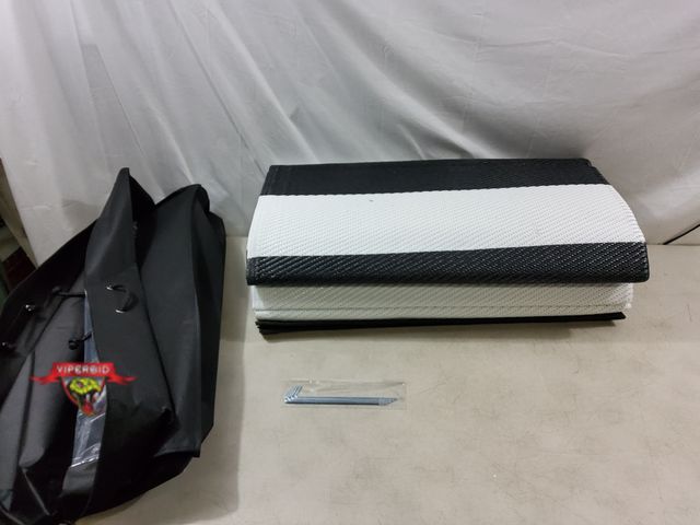 Lot 7-132675 - Approx. 9 ft. X 12 ft. Plastic outdoor mat / rug.