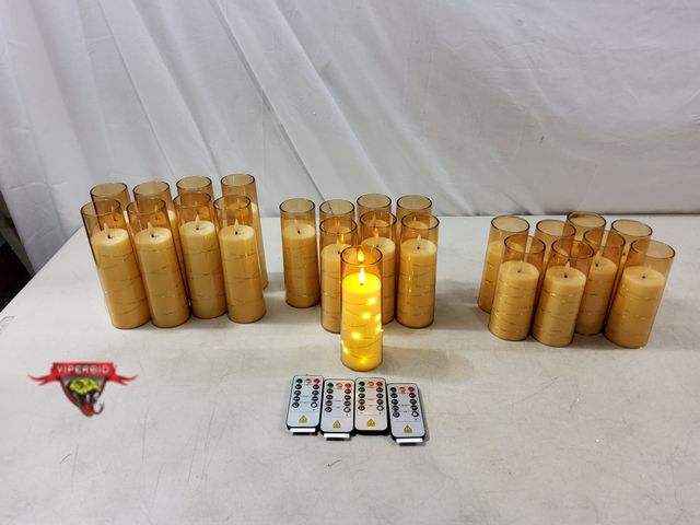 Lot 7-132838 - (24) Battery operated candles. 4 remotes included. Includes (8) 7-1/"H", (8) 6-1/2"H,  &amp; (8) 5-5...