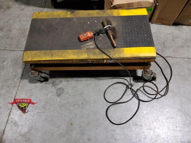 Lot 7-135916 - Econo Lift rolling hydraulic lift table. 4 ft. x 2 ft. platform. Tested - Rises / Descends.