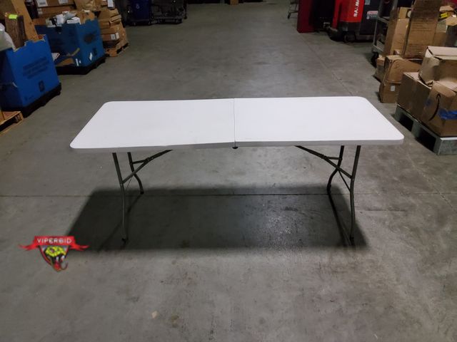 Lot 7-134943 - 27-1/2" X 6 Ft. Light duty Folding table. Top does not sit flat - still usable. Small nick on side t...
