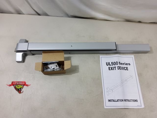 Lot 7-130069 - Dynasty Harware push bar exit device. Aluminum. #DYN-500P-36-AL-L.