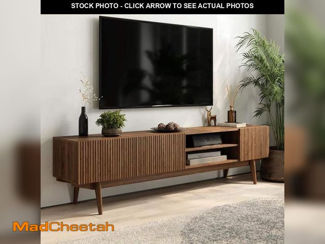 Lot 74-12409801 - (CORNERS ARE CHIPPED ) LIVING SKOG Kelly Brown TV Stand Fits TV's up to 75 in. with wooden legs - UN...