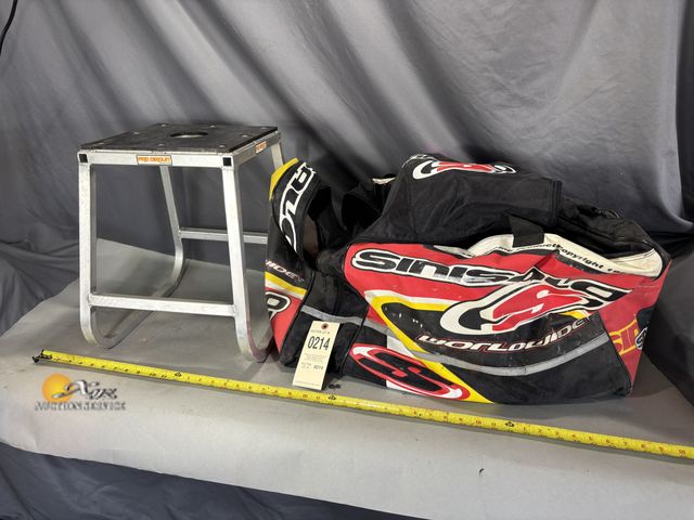 Lot 83-0214 - Pro Circuit Engine Stand and Gear bag with contents