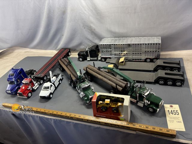 Lot 83-1455 - Lot of Semi Trucks, Logging Trucks, Flatbeds, Livestock Trailer, Tow Truck, and John Deere Grader