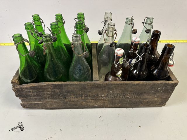 Lot 91-7295 - 18 VINTAGE GLASS BOTTLES WITH METAL HINGED RUBBER TOPPERS IN WOODEN CRATE - PLUTO WATER &amp; MEDICI...