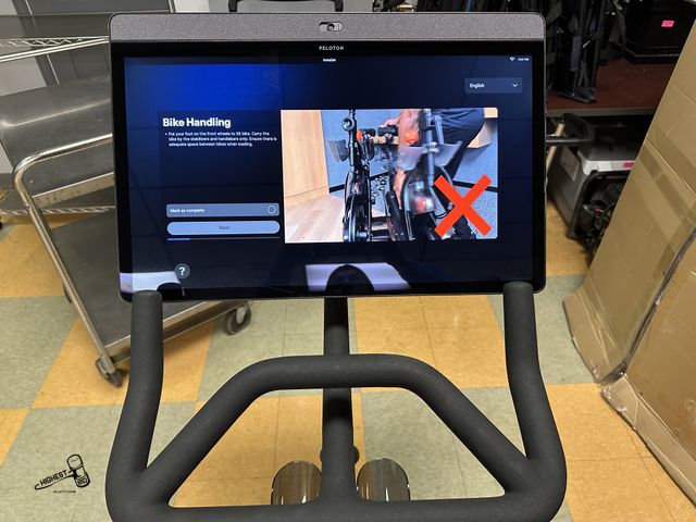 Lot 91-7542 - PELETON BIKE - WITH HAND WEIGHTS - Features: 
Get a total-body workout. A 360° rotating screen means...