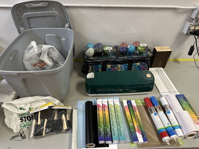 Lot 91-6410 - CRICUT EXPLORE AIR 2 WITH CARRYING CASE AND A TOTE FULL OF VINYL, CUTTING BOARD, AND FOAM BRUSHES