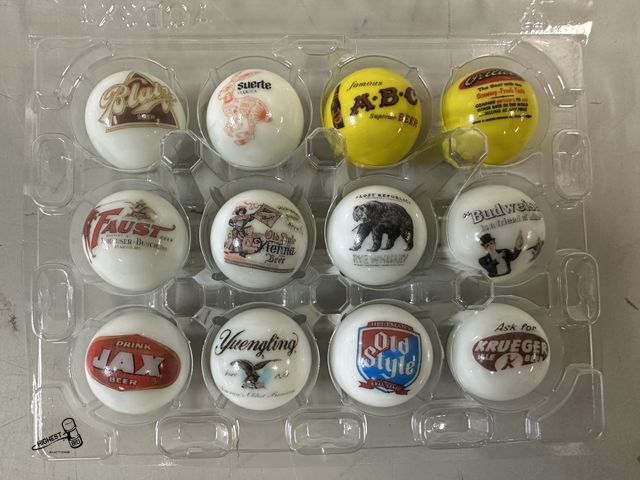 Lot 91-8983 - VINTAGE ADVERTISING MARBLES WITH VARIOUS BREWERY LOGOS 12 IN PLASTIC CASE