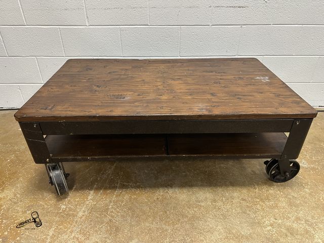 Lot 91-9468 - MAGNUSSEN HOME PINEBROOK RECTANGULAR COCKTAIL TABLE WITH LARGE CASTERS AND METAL FRAME