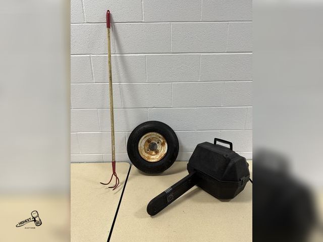 Lot 91-7055 - TRAILER TIRE WITH A CHAINSAW CASE AND A GARDEN CULTIVATOR