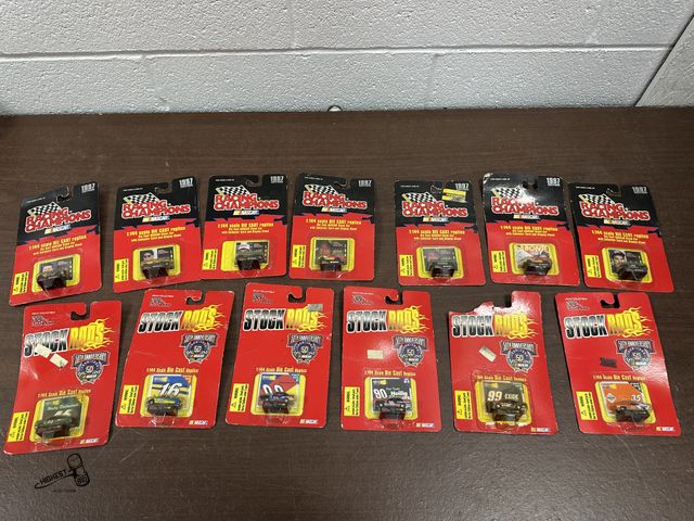 Lot 91-6604 - 13 TOTAL NASCAR RACING CHAMPIONS 1:144 SCALE DIE CAST REPLICA WITH COLLECTOR CARD AND DISPLAY STAND ...