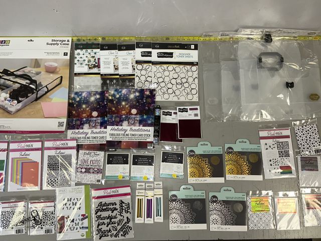 Lot 91-8376 - New TABLE FULL OF FOILS &amp; FOILABLES GO PRESS AND FOIL ME STORAGE BOXES - STORAGE &amp; SUPPLY CA...